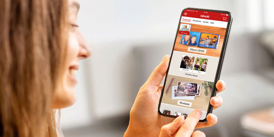 Alguien sostiene un móvil con la app CEWE, explorando la función para crear imágenes.