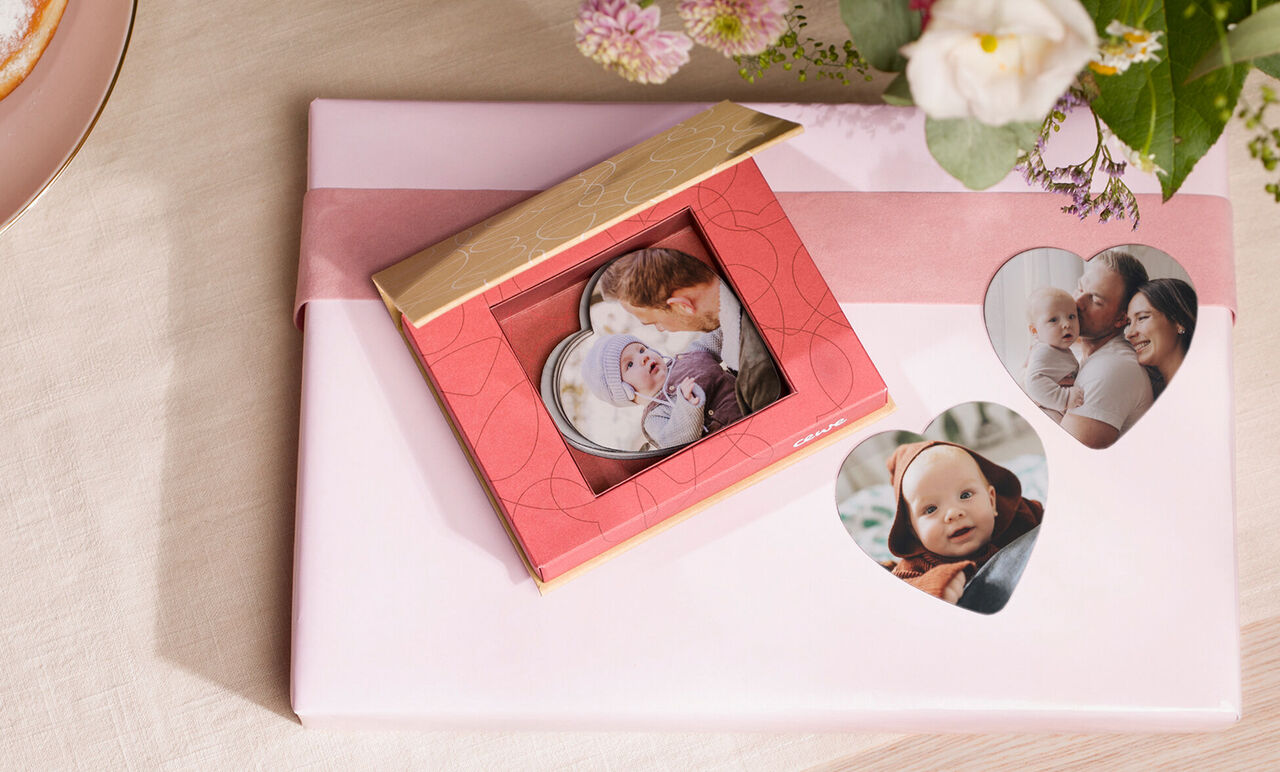 Un bonito regalo rojo con tarjetas fotográficas presentado con amor, rodeado de flores. Perfecto para regalar recuerdos.