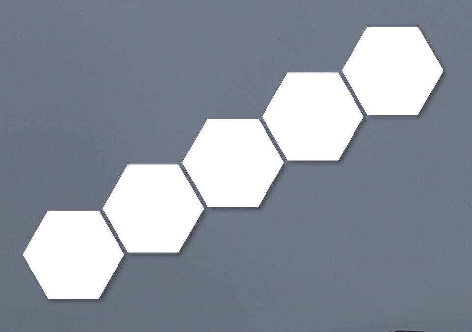 Cinco hexágonos vacíos conectados en una pared gris